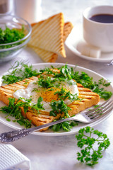 Fried eggs, croutons and salad with coffee