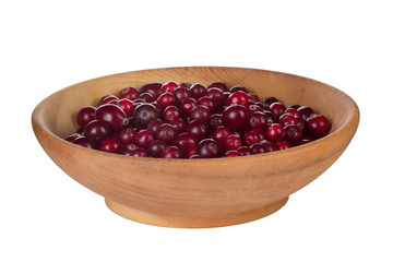 heap of fresh cranberries in wooden cup isolated