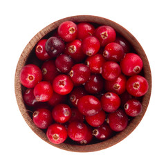 heap of fresh cranberries in wooden cup isolated. top view