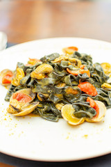 Seafood pasta dish, Italian black fettuccini with vongole clams and mussels