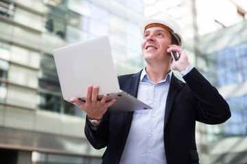 Smiling worker talking at mobile phone