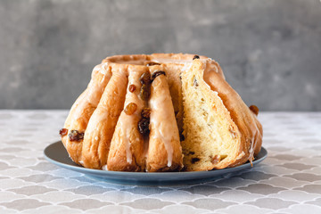 Traditional yeast ring cake with icing and raisins.