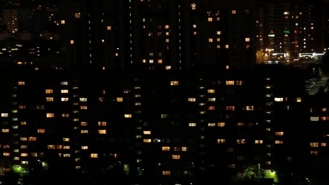 View of the night multi-storey houses. Lots of lights in the windows. Dormitory area.