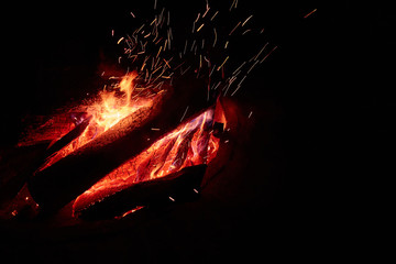 Big campfire at night with a lot of sparks