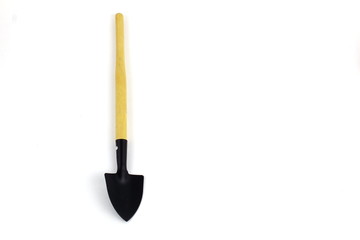 Black metal spade on wooden handle.