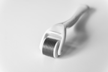 Black and white image of dermaroller for home mesotherapy on white background, copy space,...
