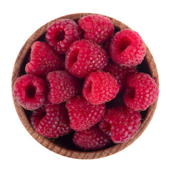 heap of red raspberries in wooden cup isoalted on white background. top view