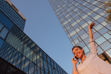 Fototapeta premium business, communication, technology and people concept - young smiling african american businesswoman calling on smartphone in city