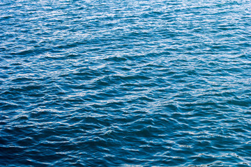 Blue sea surface with waves. Bright and contrasting sea concept.