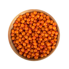 heap of sea buckthorn in wooden cup isolated. top view