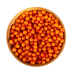 heap of sea buckthorn in wooden cup isolated. top view