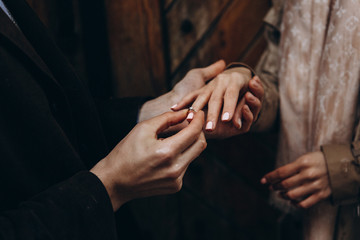 Young man makes a proposal to get married and put ring on finger. She said yes