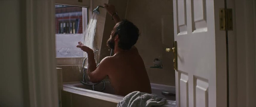 Young man enjoying hot shower