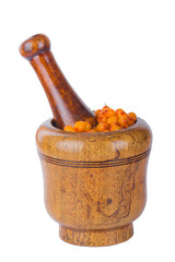 sea buckthorn in wooden mortar isolated on white background
