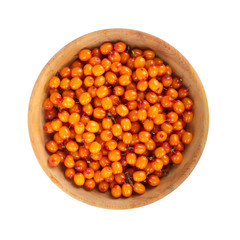 heap of sea buckthorn in wooden plate isolated. top view
