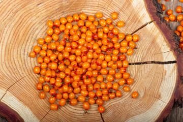 heap of sea buckthorn on wooden background