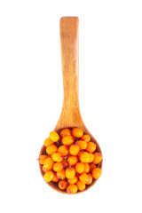 heap of sea buckthorn in wooden spoon isolated on white