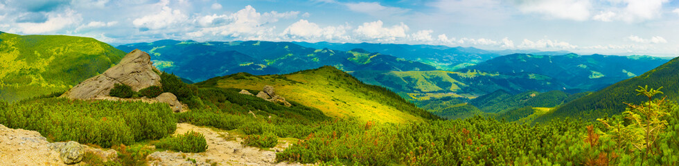 Carpathians in summer day. Mountains against the sunny blue sky with clouds on background