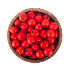 heap of red ashberries in wooden cup isolated. top view