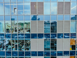 Fototapeta na wymiar Street reflection on glass steel building facade