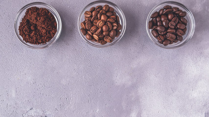 Fototapeta na wymiar Different varieties of coffee beans on dark background. Top view. Copy space. Toned photo