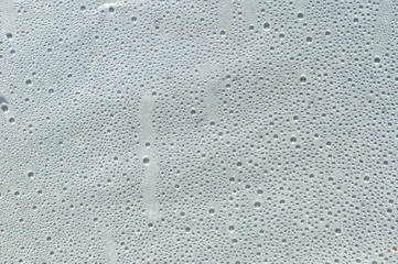 Many small drops of water on plastic film.