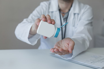 jar with medicine in hand at the doctor, pills, for text