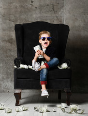 Happy young boy crazy screaming excited hold stack of dollars money. Guy celebrates success lots of money dollar bills