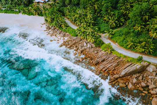 Aerial photo of coastal road along paradise tropical rocky beach at Seychelles. Summer vacation, travel and lifestyle concept
