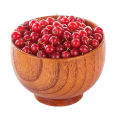 heap of red bird cherry in wooden cup isolted on white