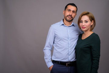 Multi-ethnic couple in love against gray background