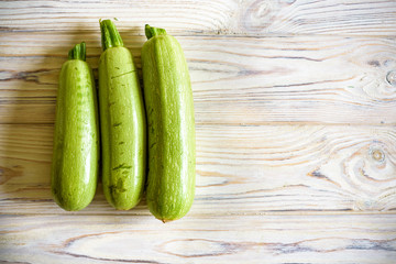 Fresh zucchini on wooden background. Top view.