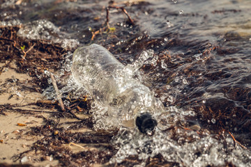 Old used plastic bottles on the Mississippi River