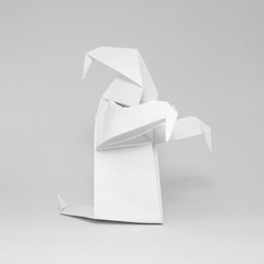 Photo of white origami ghost isolated on white background