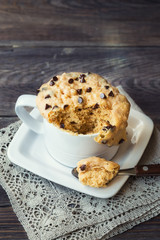 Cake in mug with peanut butter and chocolate chips