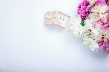 Set of silver ring and earrings with pearls in the gift box with peonies. Present for holiday