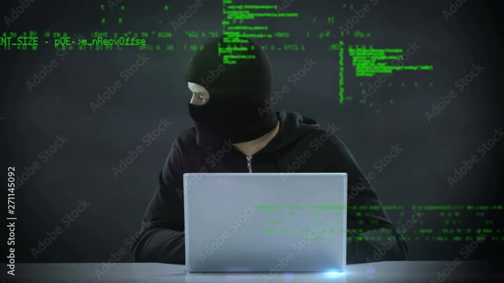 Poster hacker using a laptop