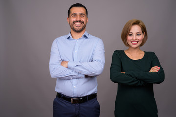 Multi-ethnic couple in love against gray background