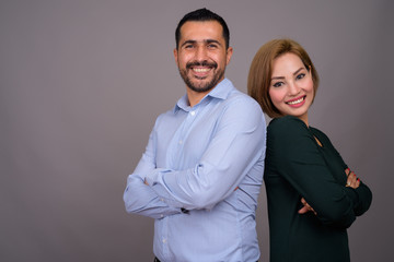 Multi-ethnic couple in love against gray background