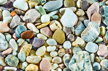 Close up picture of a collection of water-rolled stones with different shapes and colors
