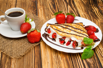 Crepes with Banana, Chocolate and strawberries on a wooden background, pancakes.