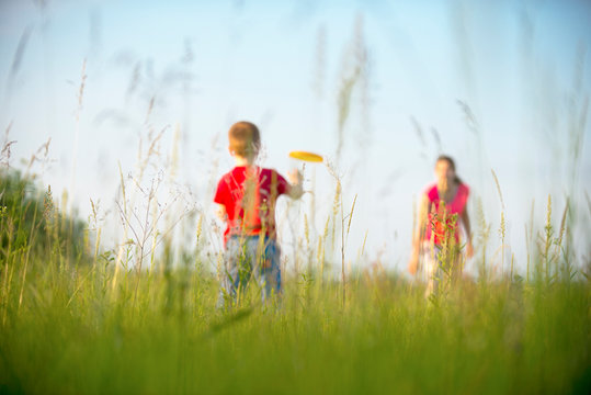 Mom and son play frisbee, Chernigov, Ukraine, May 30, 2019.