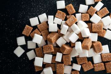 White and brown sugar cubes closeup.