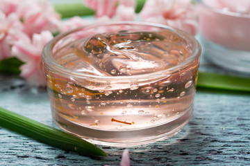 cosmetic creams with pink hyacinth flowers, on old cracked blue table