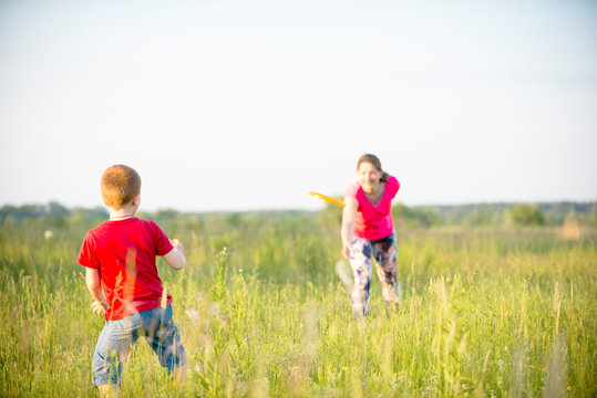 Mom and son play frisbee, Chernigov, Ukraine, May 30, 2019.