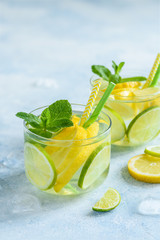 Fresh cool lemon lime mint water in glasses, detox, healthy food. Close up, selective focus