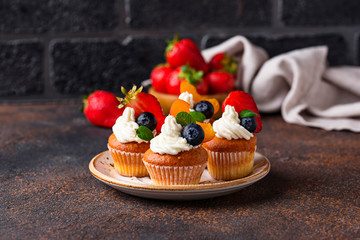 Cupcakes with cream and berries