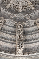 Fototapeta na wymiar Bas-relief with dancing Apsara at famous ancient Ranakpur Jain temple in Rajasthan state, India