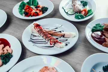 tubes with cream filling and other dishes on the table