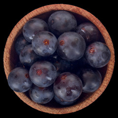 heap of blue grapes isolated on black. top view